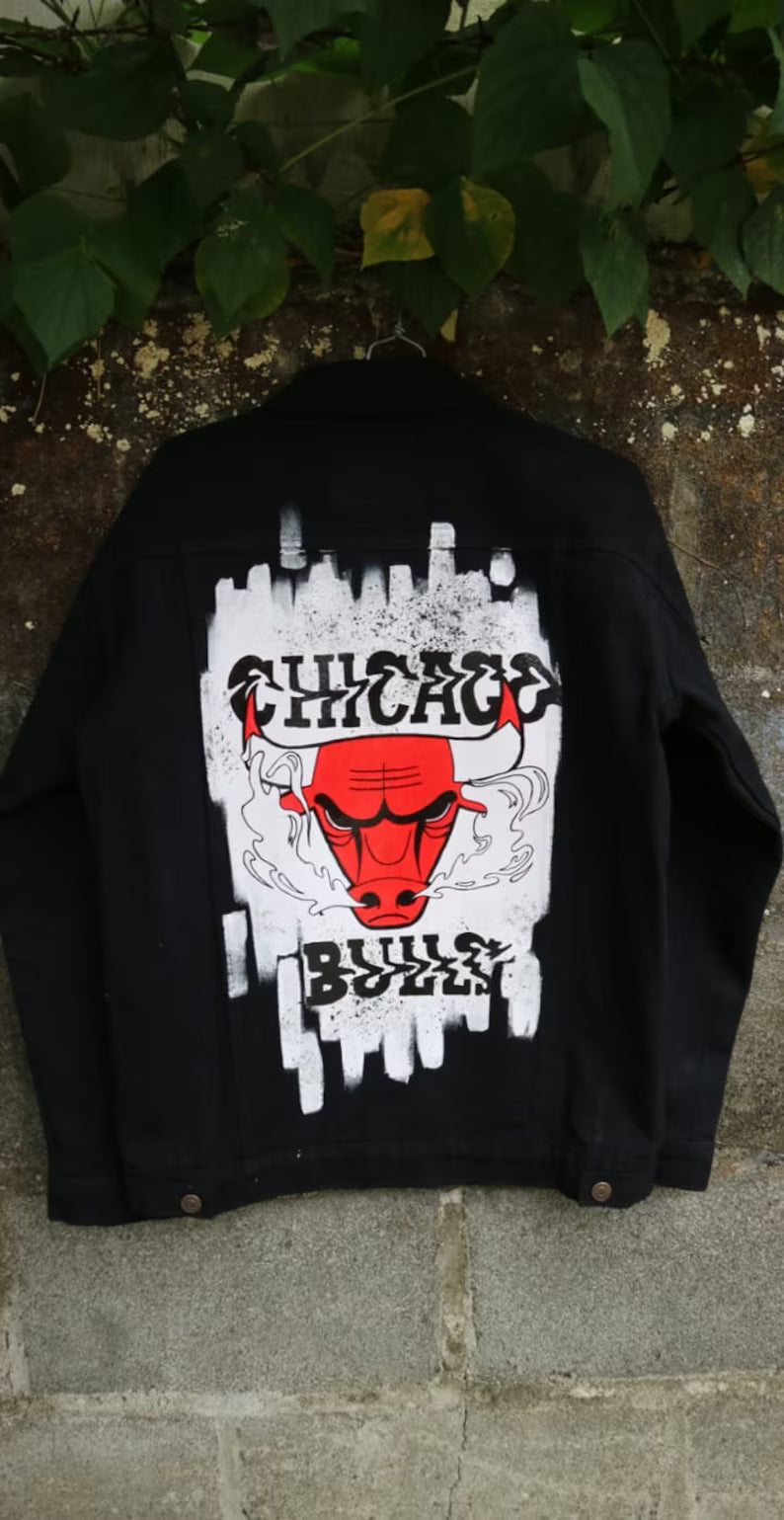 Custom Painted Streetwear Black jacket with Chicago Bulls logo on a stone wall background
