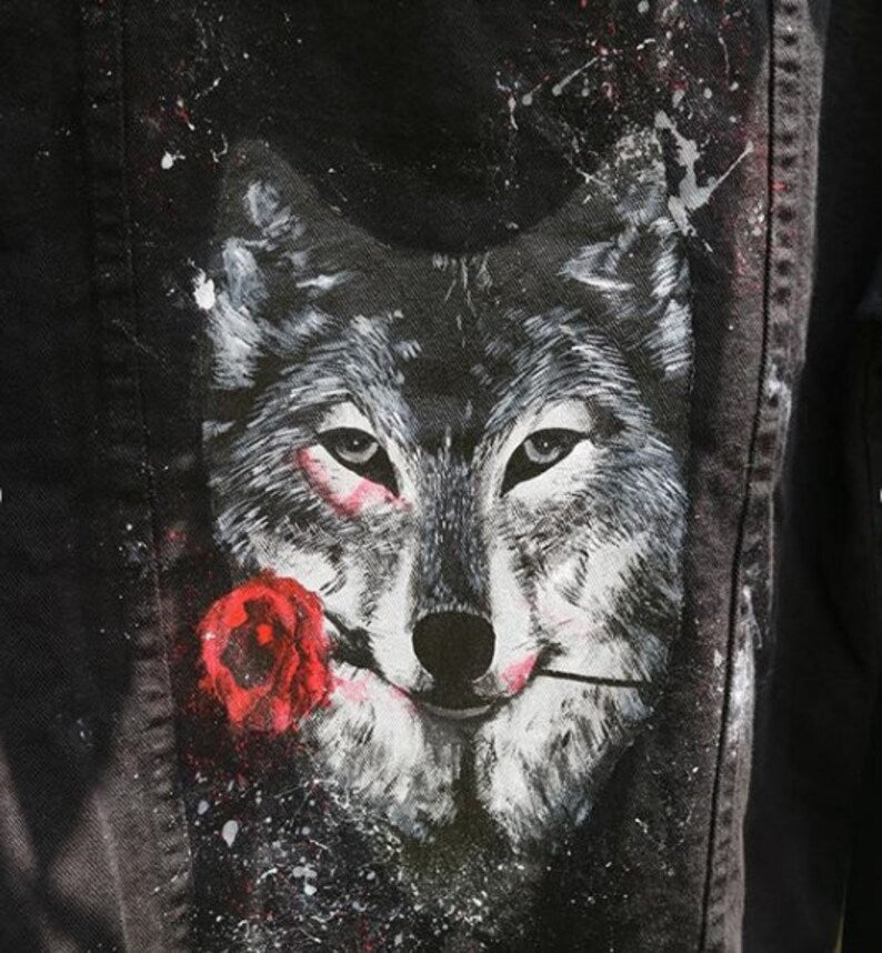 Wolf with a red rose on a denim jacket