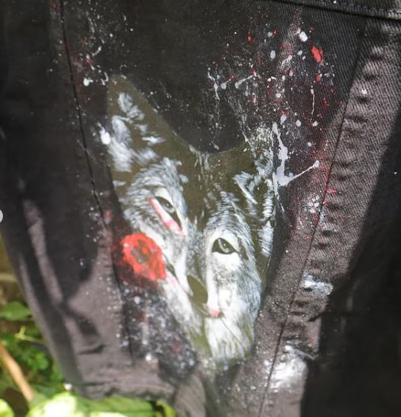 Close-up of a graphic design on a jacket with a wolf and red eye design.