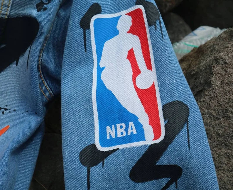 Hand-Painted Basketball Legend NBA logo patch on a denim jacket with black graphics.