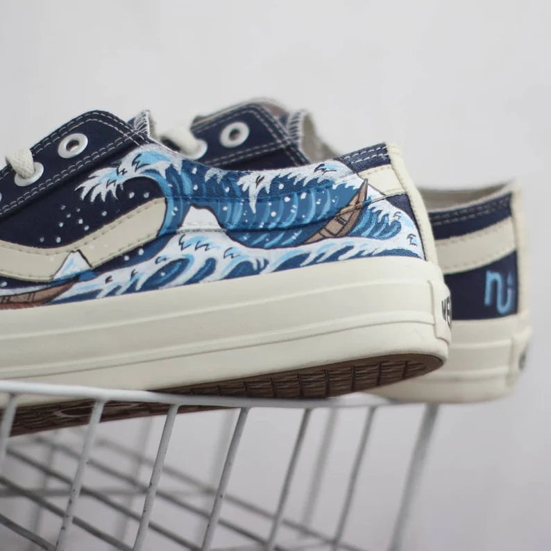 Navy blue and white sneakers with wave design on a white background
