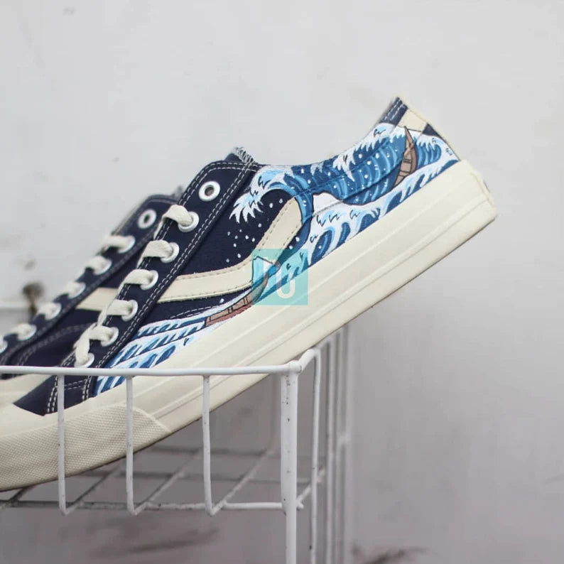 Custom Painted Sneakers Navy blue and white sneakers with wave design on a gray background