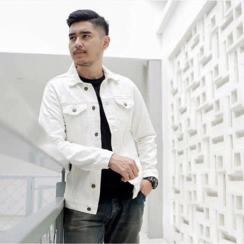 Man wearing a white denim jacket in a modern indoor setting