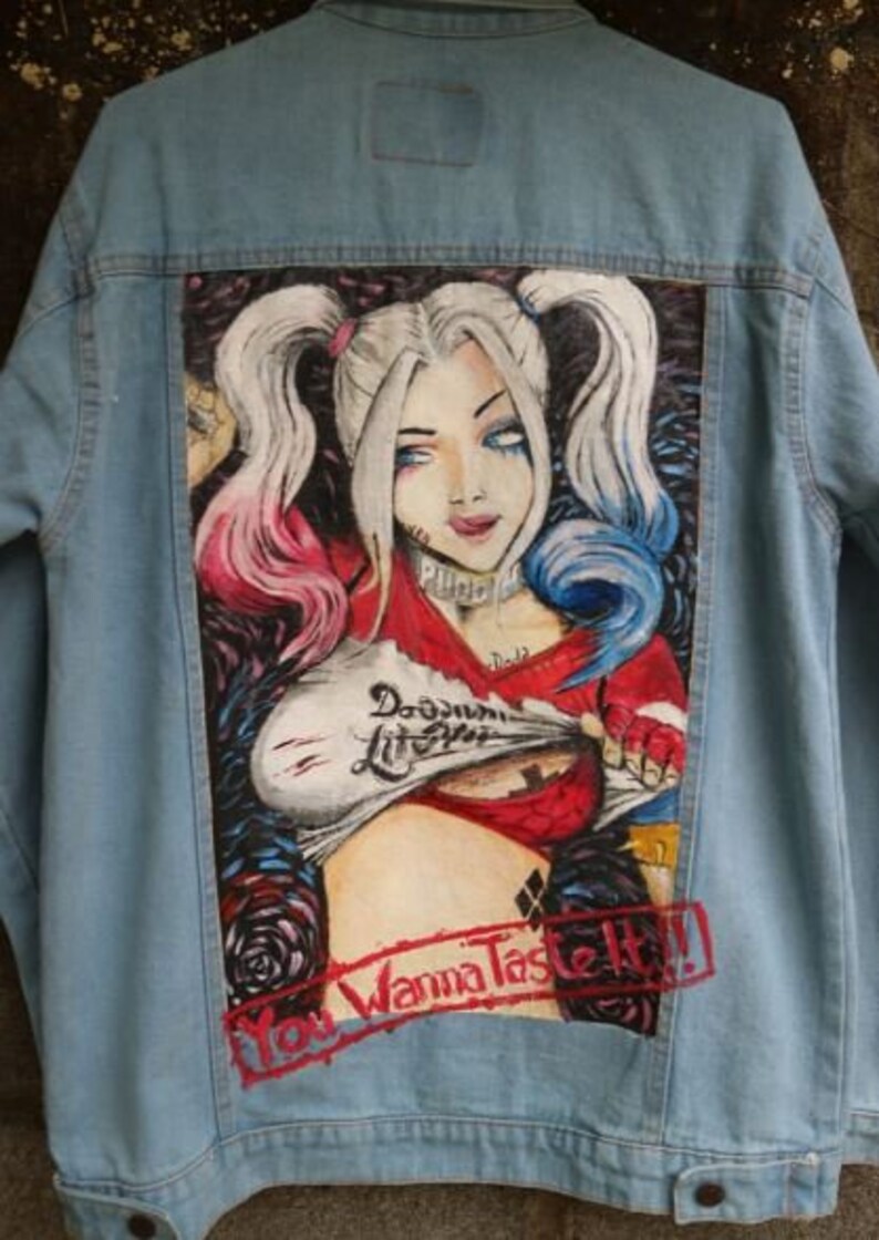 blue Denim jacket with a graphic design of a character with colorful hair and text on a dark background