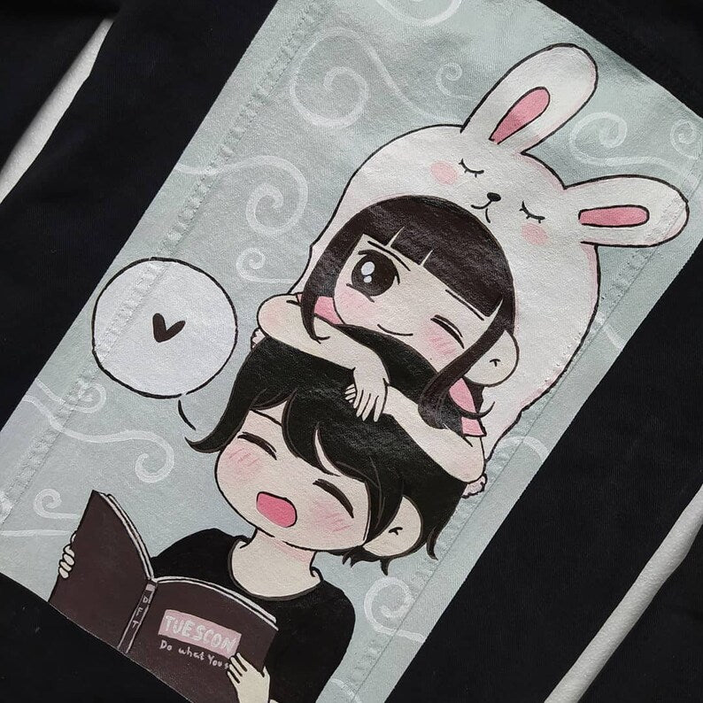 hand painted no denim jacket of two people with bunny ears on a light gray background