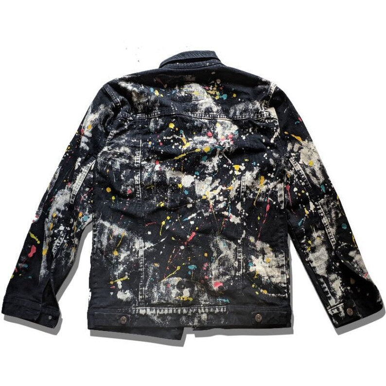 Abstract Expressionism Black denim jacket with colorful paint splashes on a white background