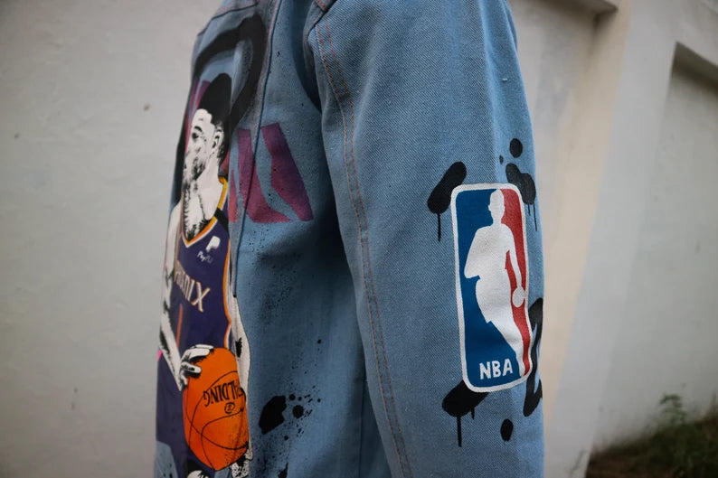 NBA Iconography Blue denim jacket with Sport-Luxe and colorful graphics on a plain background