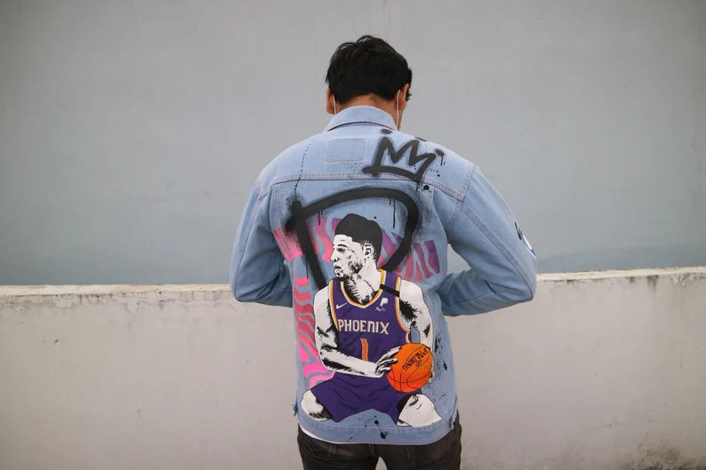 Person wearing a Basketball Clothing UK denim jacket with a graphic design of a basketball player on the back.