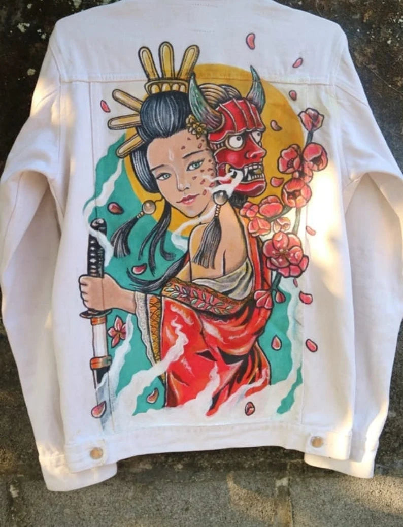 White jacket with a colorful graphic design of a woman holding a sword and a demon mask.