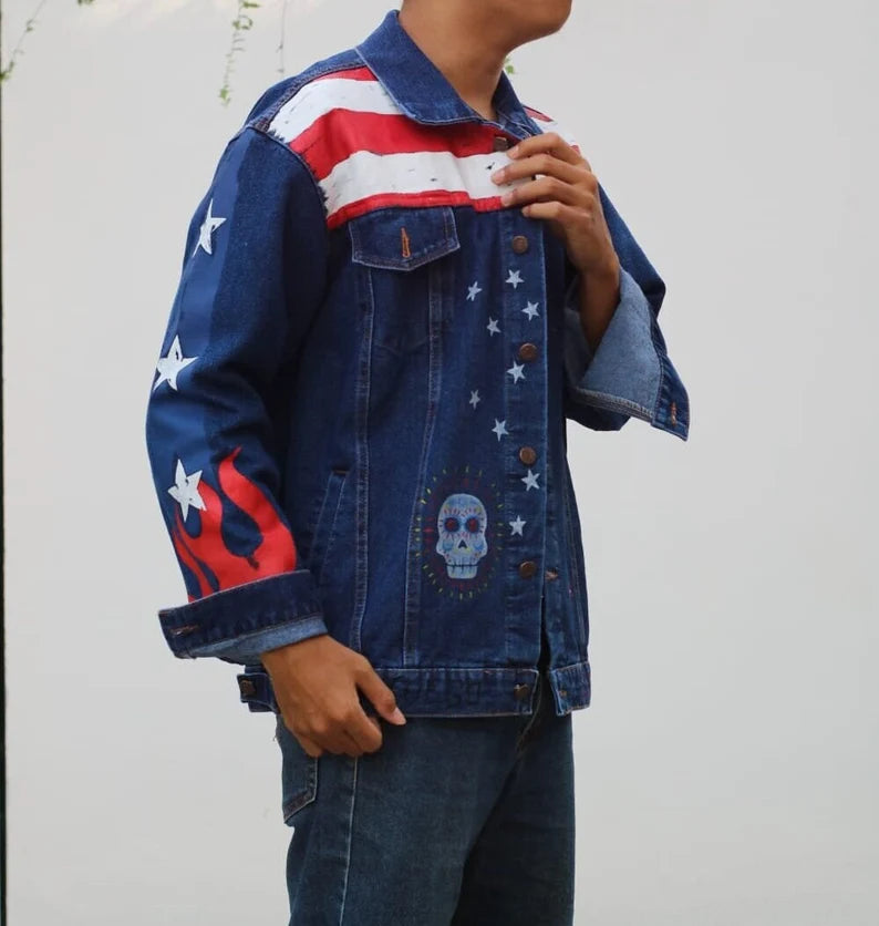 Person wearing a Hand Painted Marvel denim jacket with American flag design and skull illustration.