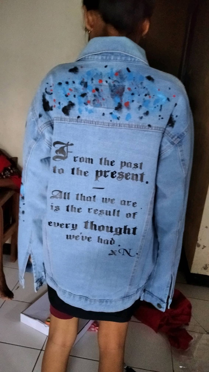 Custom Painted NCT Merch Light blue denim jacket with text and paint splashes worn by a person indoors.