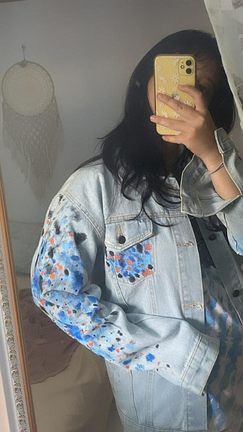 Person wearing a light blue Korean Style Denim Jacket with colorful floral patterns, taking a mirror selfie.