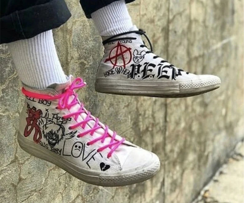 Custom Lil Peep Sneakers White sneakers with colorful graffiti-style designs on a stone surface