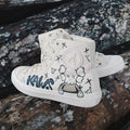 hand-painted cartoon companion White high-top sneakers with black and blue designs on a wooden surface