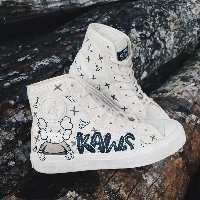 Custom Kaws Inspired White high-top sneakers with cartoon character and 'Kaws' branding on a wooden surface.