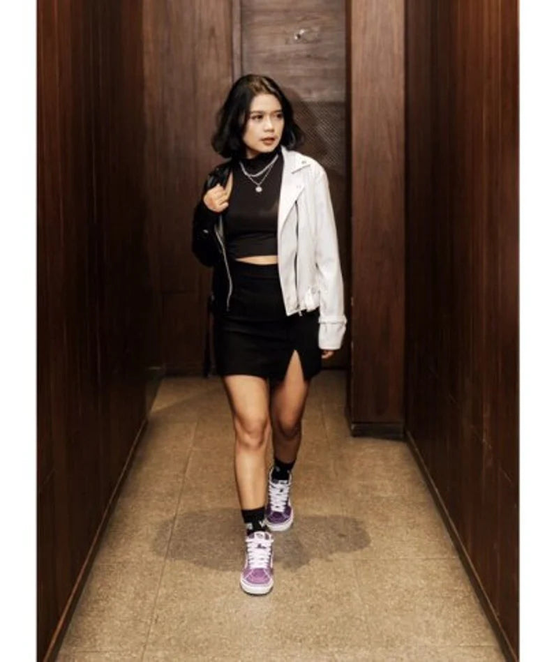 Woman walking in a hallway wearing a Hand Painted Cropped Biker Jacket