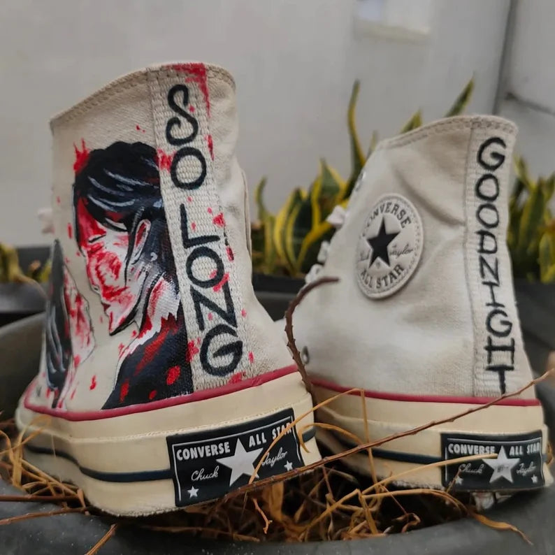 Pair of Converse high-top sneakers with MCR Merch design and text on a neutral background