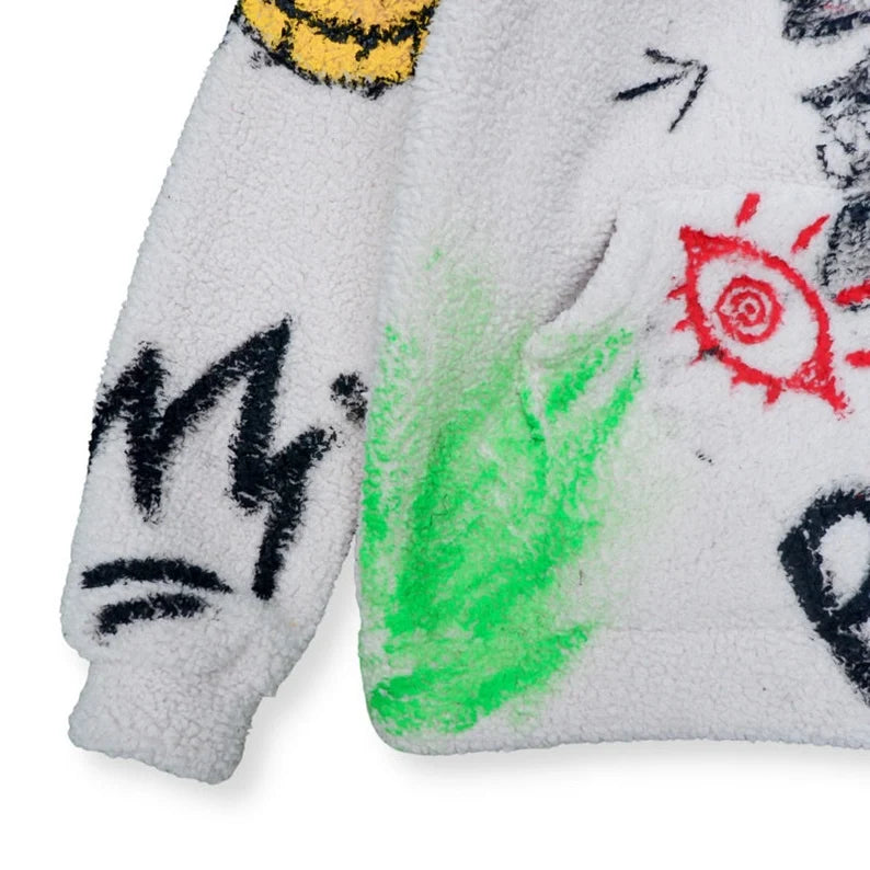 Street Art Hoodie Close-up of a textured surface with colorful abstract designs and text.