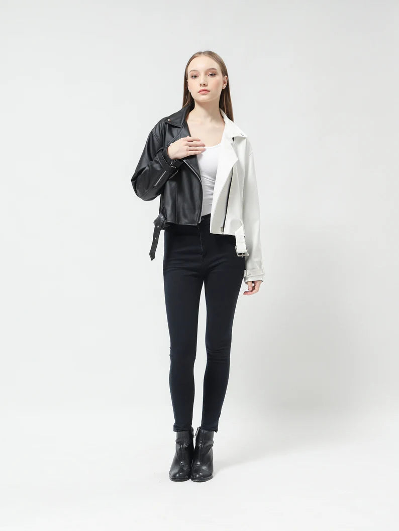 Woman wearing a crop black and silver jacket on a white background