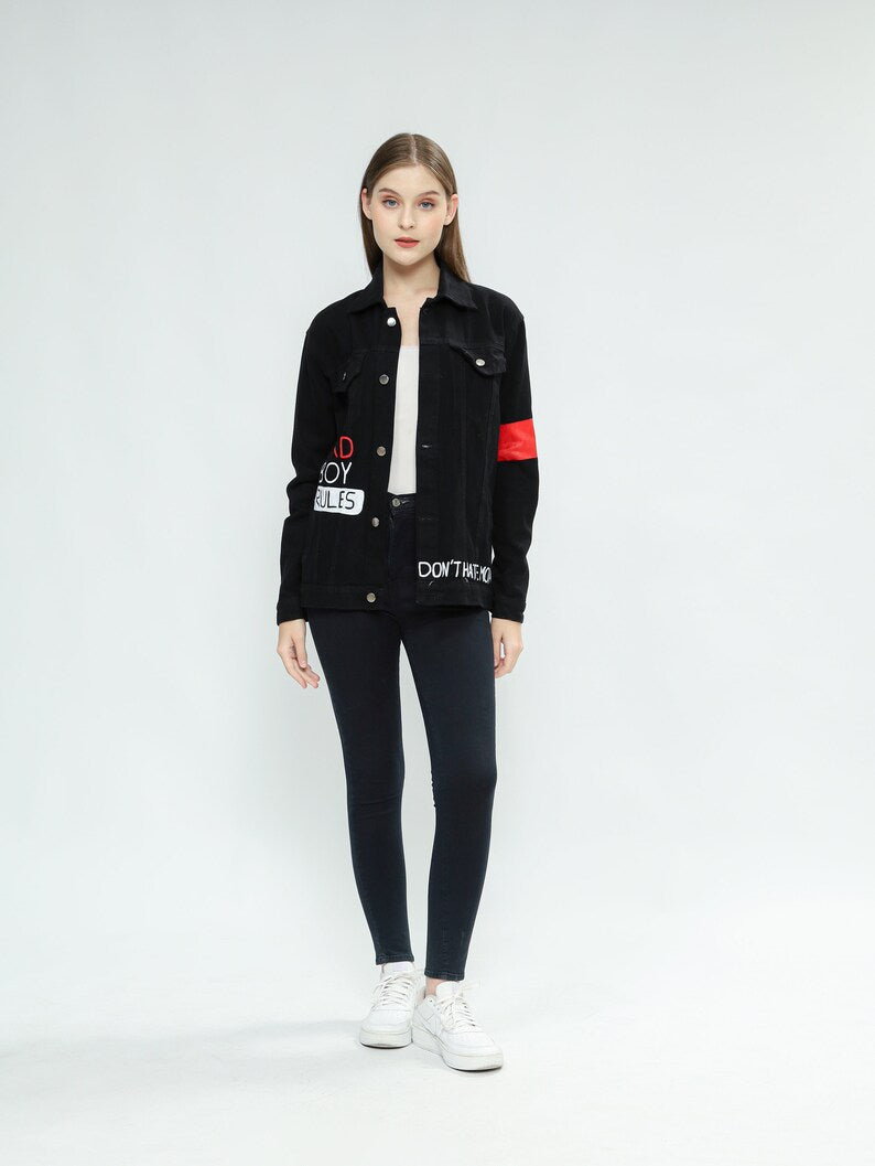Street Art Cosplay Person wearing a Harley Quinn black jacket with text, white shirt, black pants, and white sneakers on a white background
