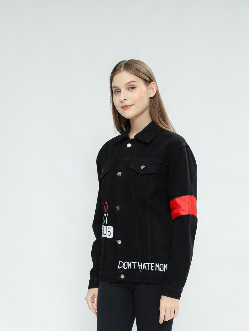 Person wearing a black jacket with red accents and text on a white background
