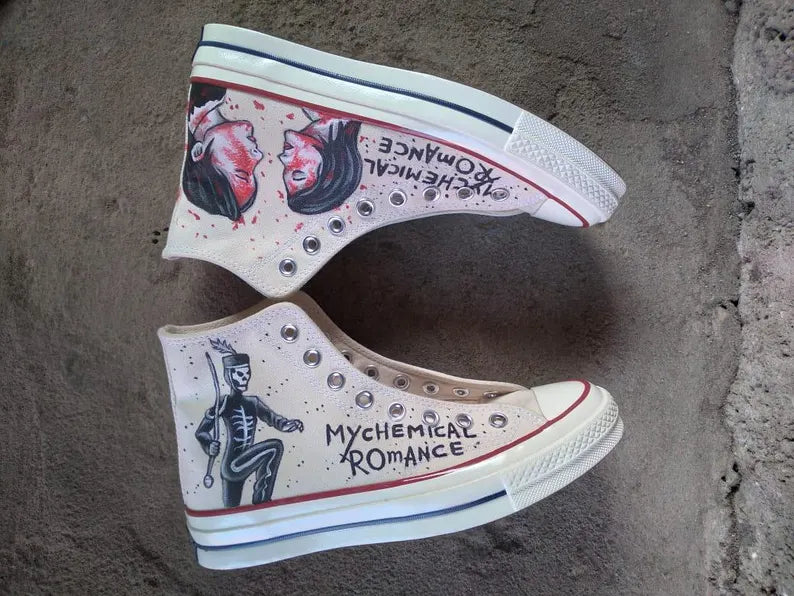 Pair of white sneakers with artistic The Black Parade designs and text on a textured surface