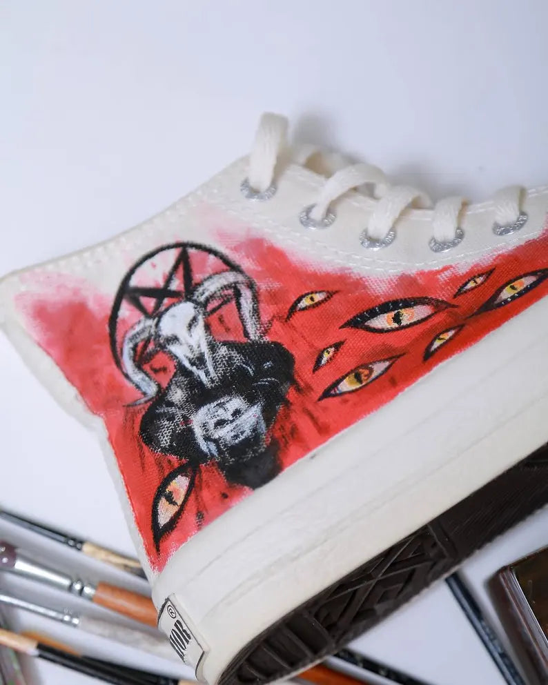 Black Metal Painted shoe with a goat head design on a white background