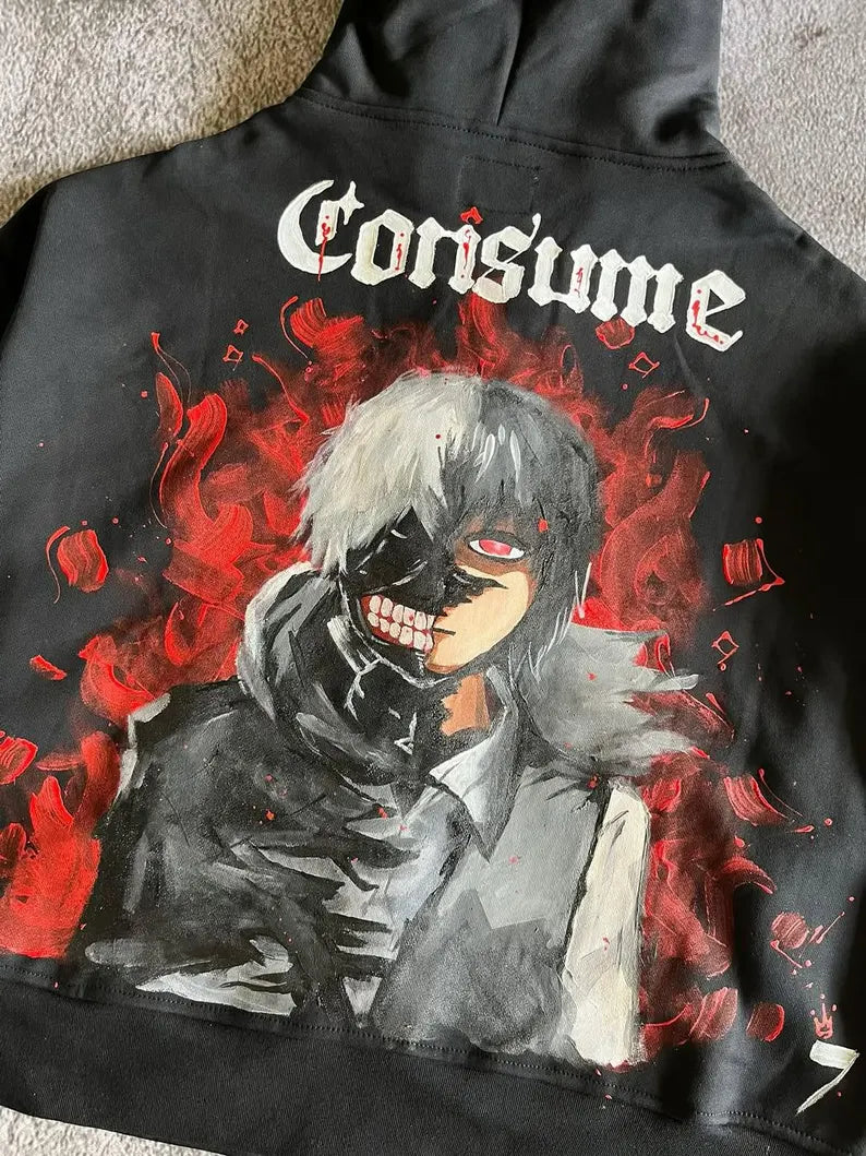 Hand Painted Anime Streetwear hoodie with graphic design of a character and the word 'Consume' on a textured surface.