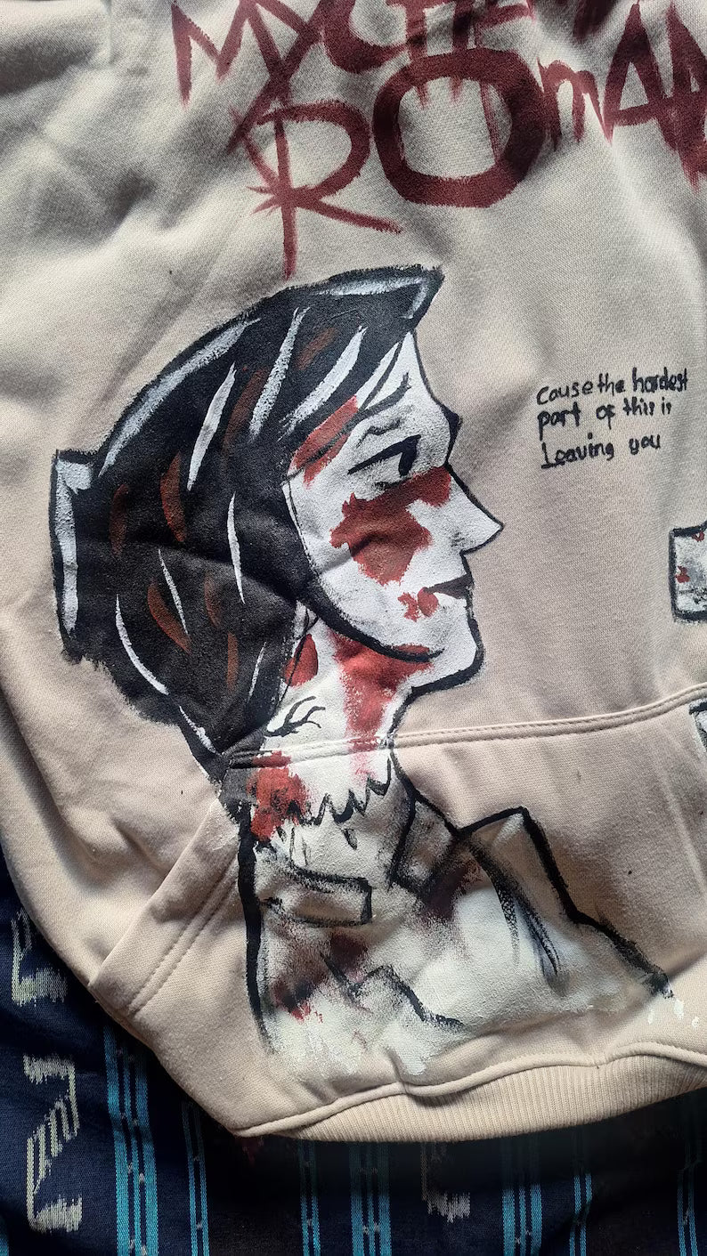 My Chemical Romance hoodie with a graphic design of a face and text on a beige background