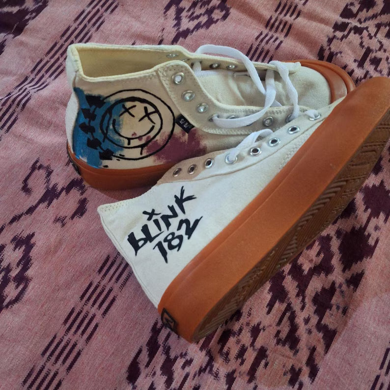 Pop Punk Streetwear Pair of sneakers with 'Blink 182' logo on a patterned surface
