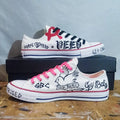 Custom hand-painted Lil Peep sneakers with black and pink text and graphics on a wooden surface.